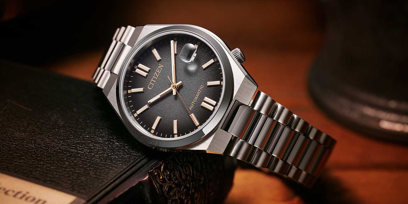 Citizen automatic watch with a black dial and silver bracelet.