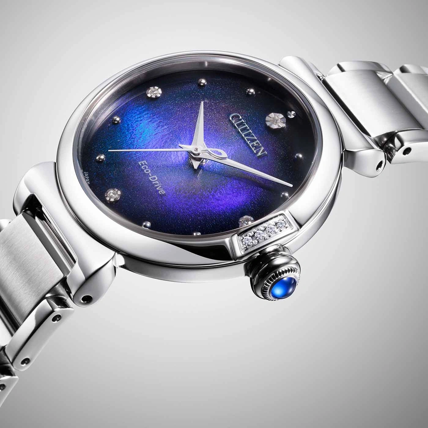Citizen watch with a blue and purple dial, diamonds, and a silver band.