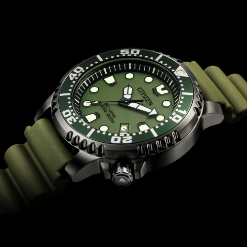 Citizen watch with green face and strap, black background, close-up shot