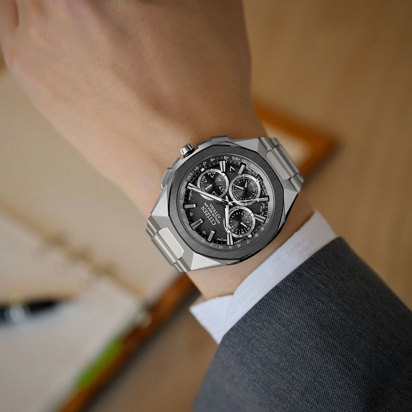 Citizen Attesa watch on wrist, grey suit, close-up, luxury timepiece, elegant design