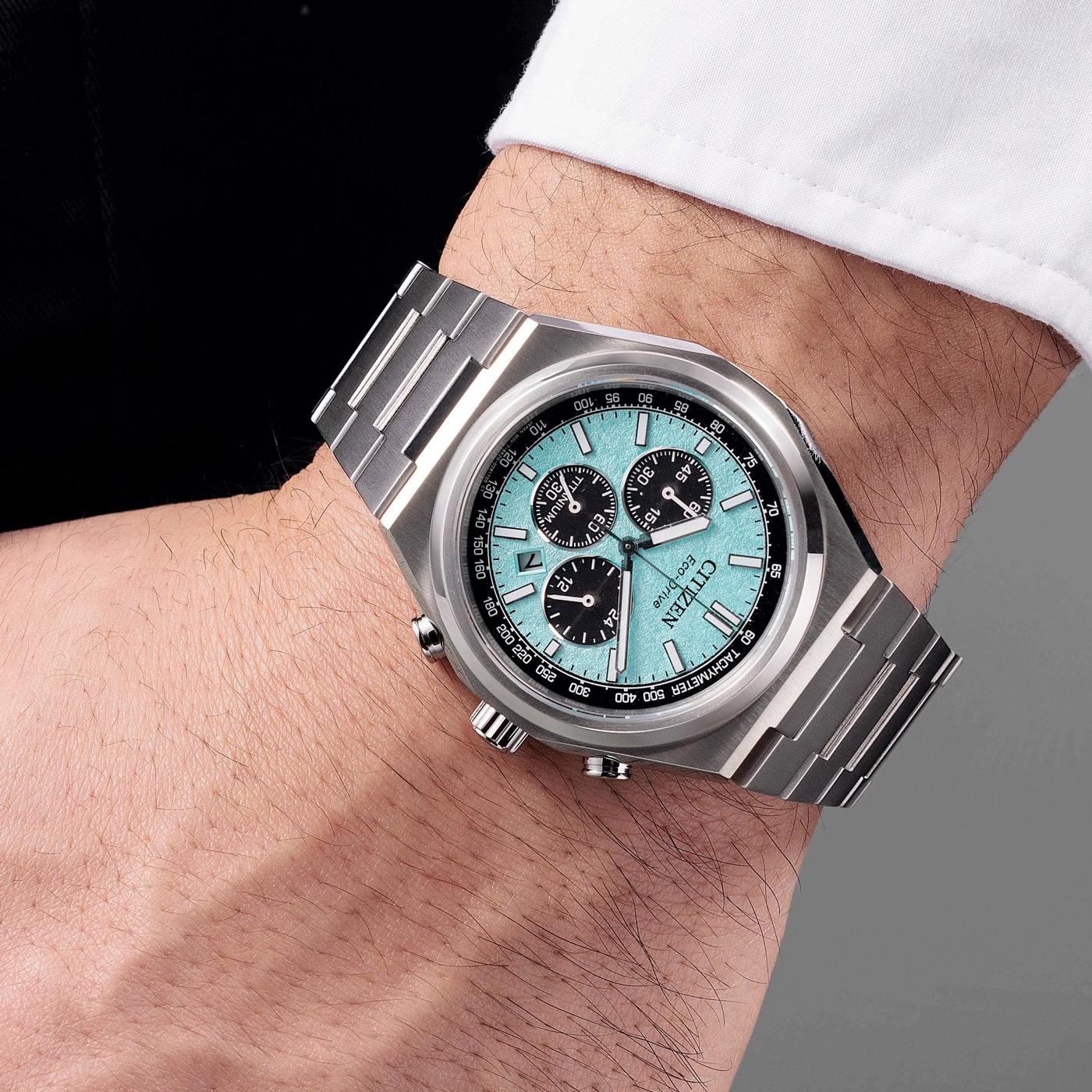 Citizen watch on wrist, turquoise face, chronograph, titanium, Eco-Drive, stylish accessory