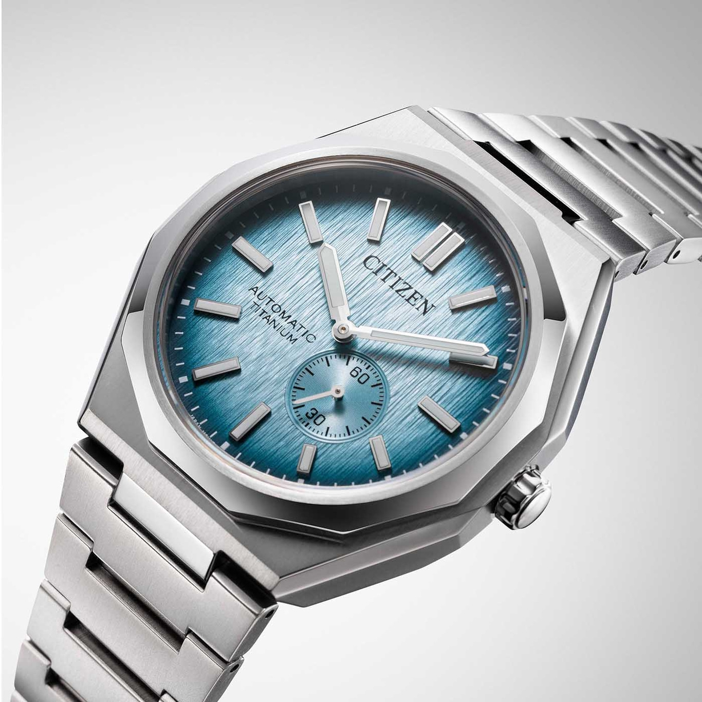 Citizen watch with blue face and titanium strap, automatic movement.