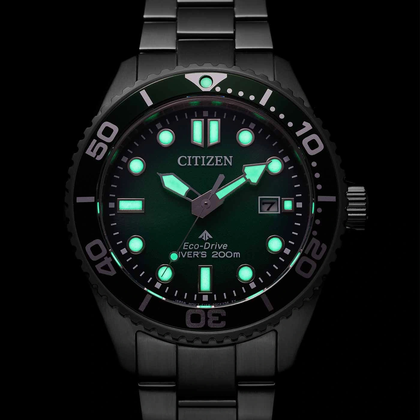 Citizen Eco-Drive Diver's watch with green luminous dial and black bracelet.
