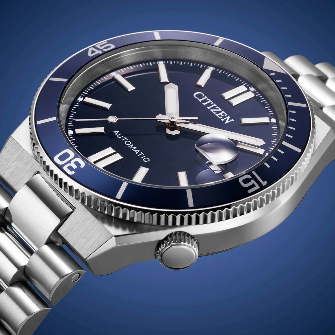 Close-up of a Citizen automatic watch with a blue dial and bezel.