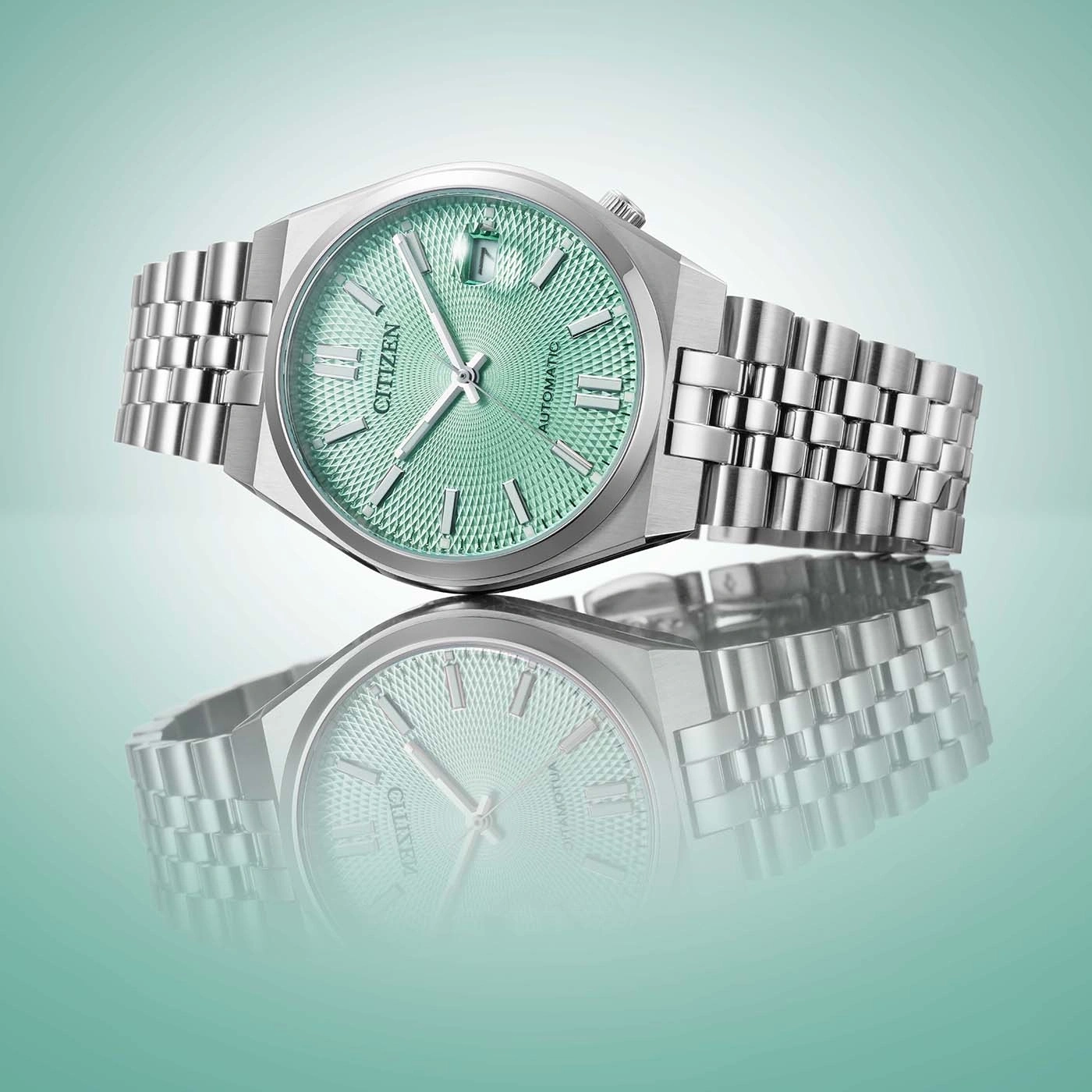 A Citizen automatic watch with a green textured dial and stainless steel band.