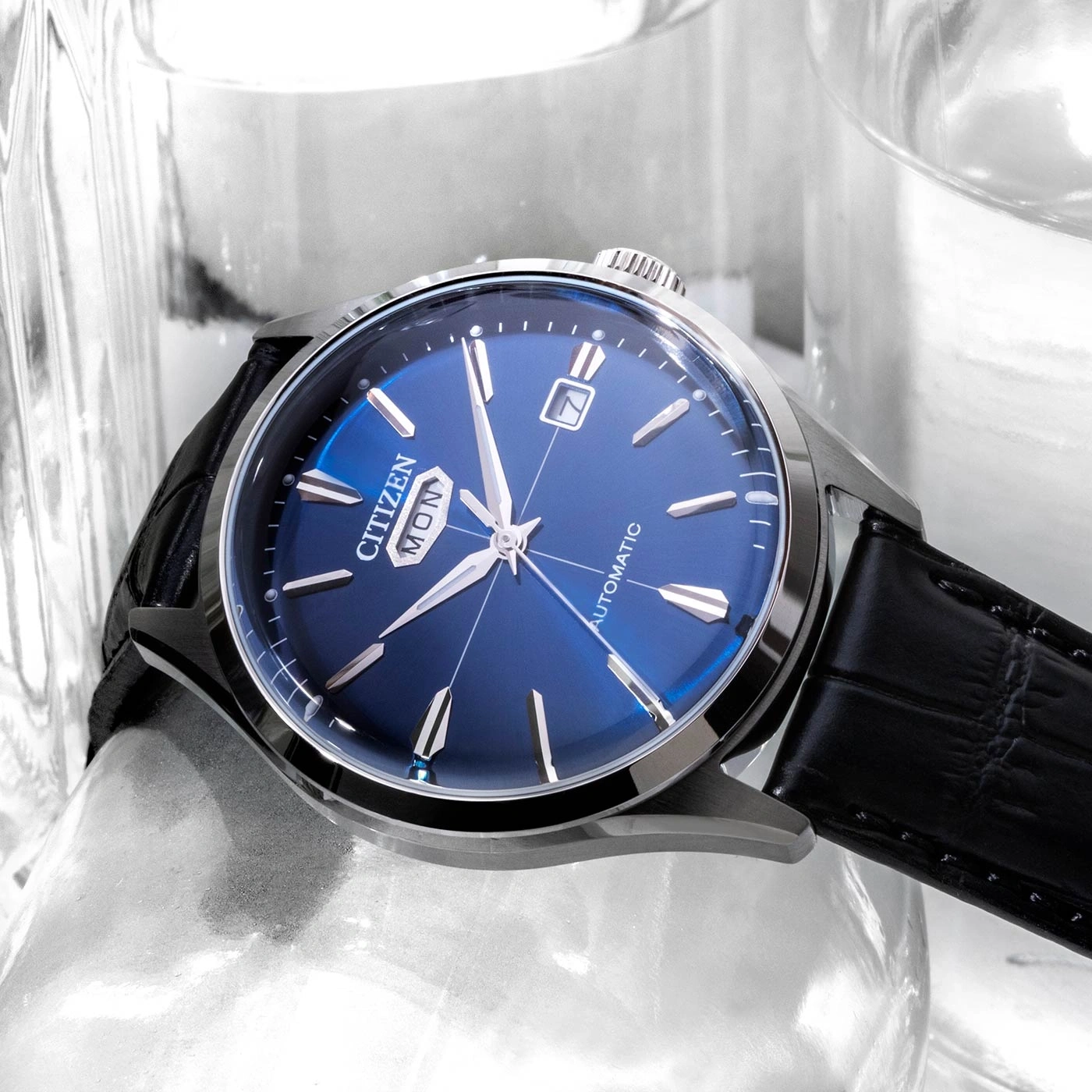 Citizen watch with blue face and black leather strap, automatic.