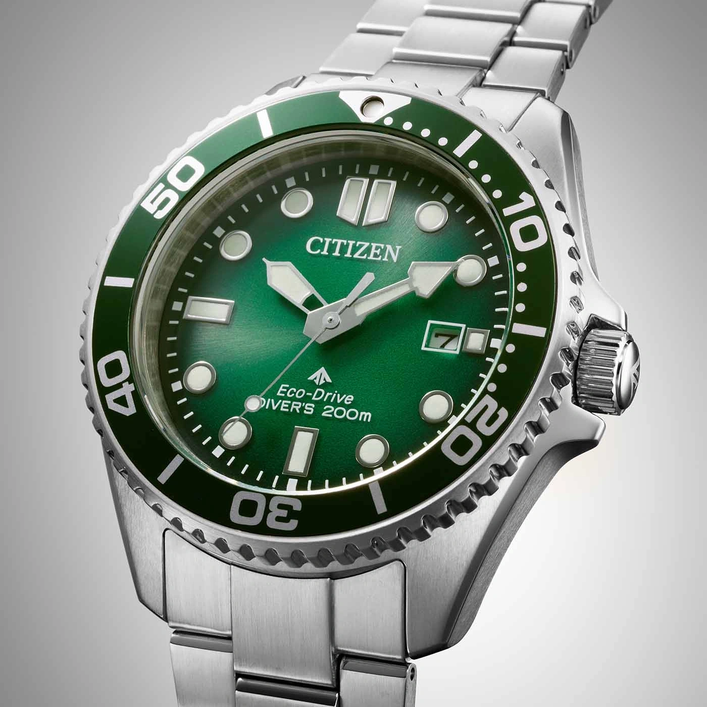 Citizen Eco-Drive diver's watch with green dial and bezel, stainless steel bracelet.