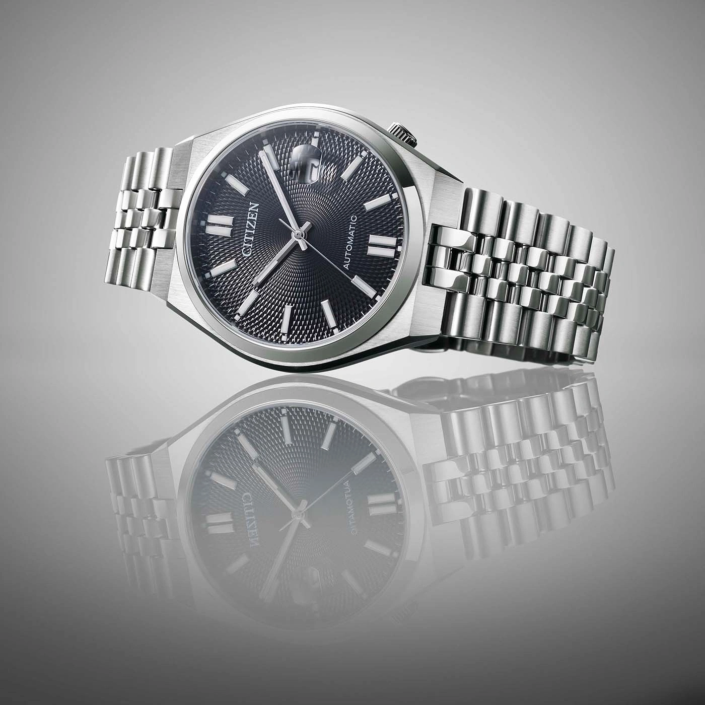 Citizen watch with a black dial and silver bracelet, reflection.