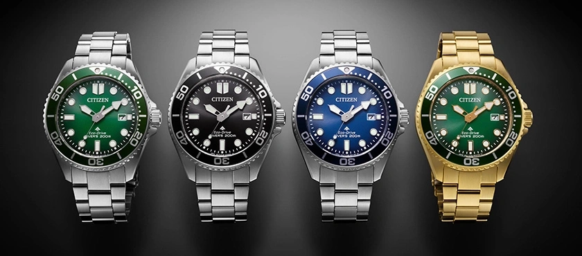 Four Citizen watches with different colored dials and bezels, stainless steel and gold.