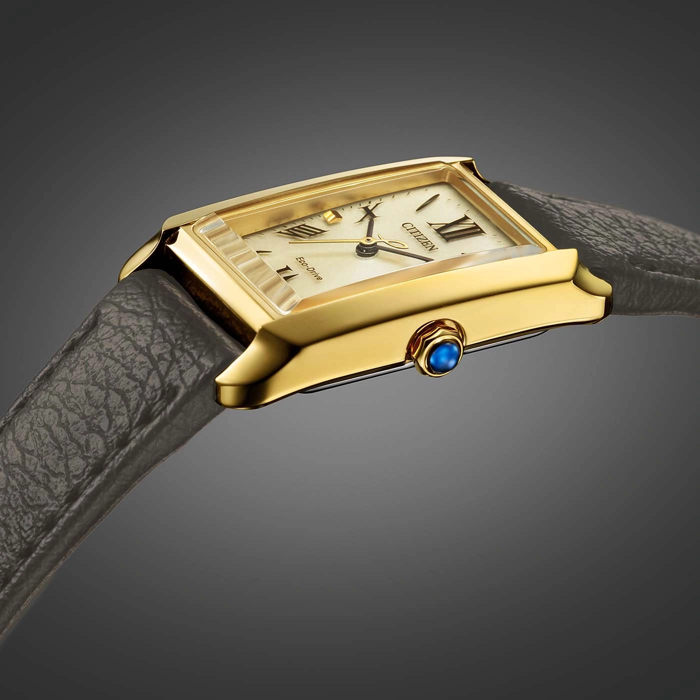 Gold Citizen watch with a rectangular face and leather strap.