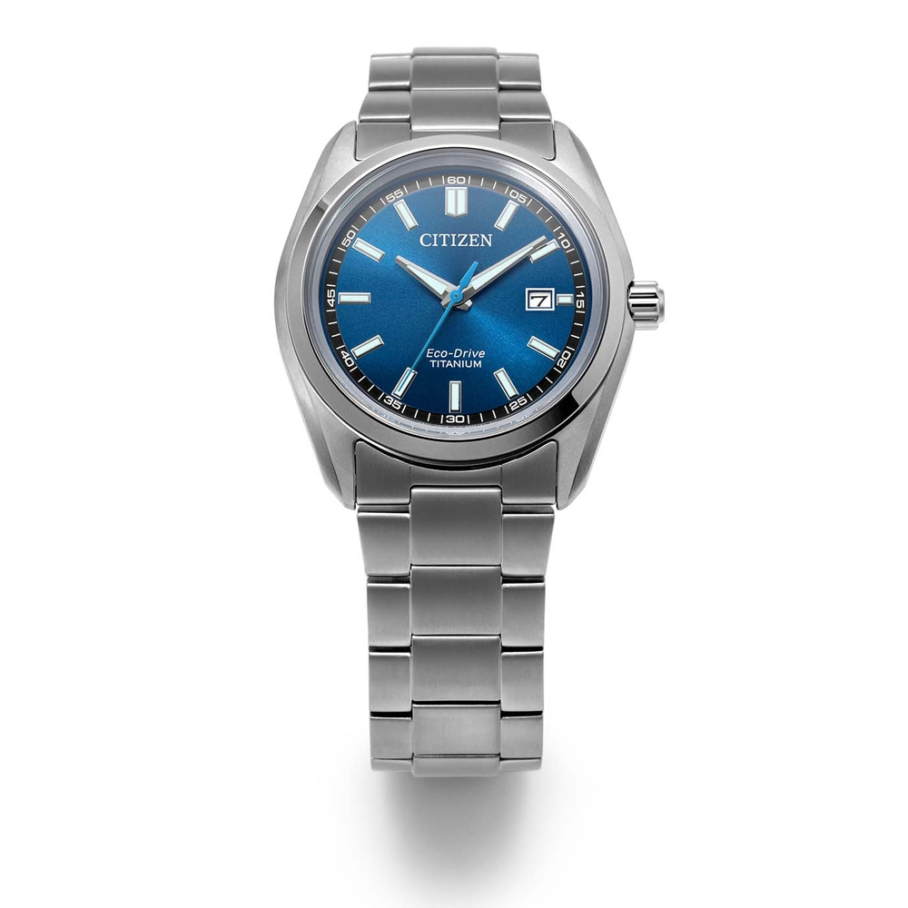 A close-up shot of a Citizen Eco-Drive Titanium watch with a blue dial and steel band, set against a white background.