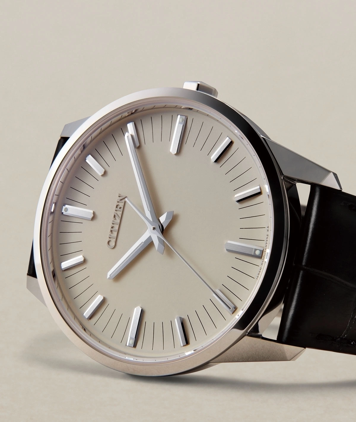 Close-up of a Citizen watch with a silver case and black strap.