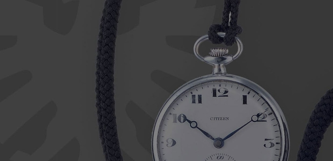 Close-up of a Citizen pocket watch with a black cord, elegant and vintage.