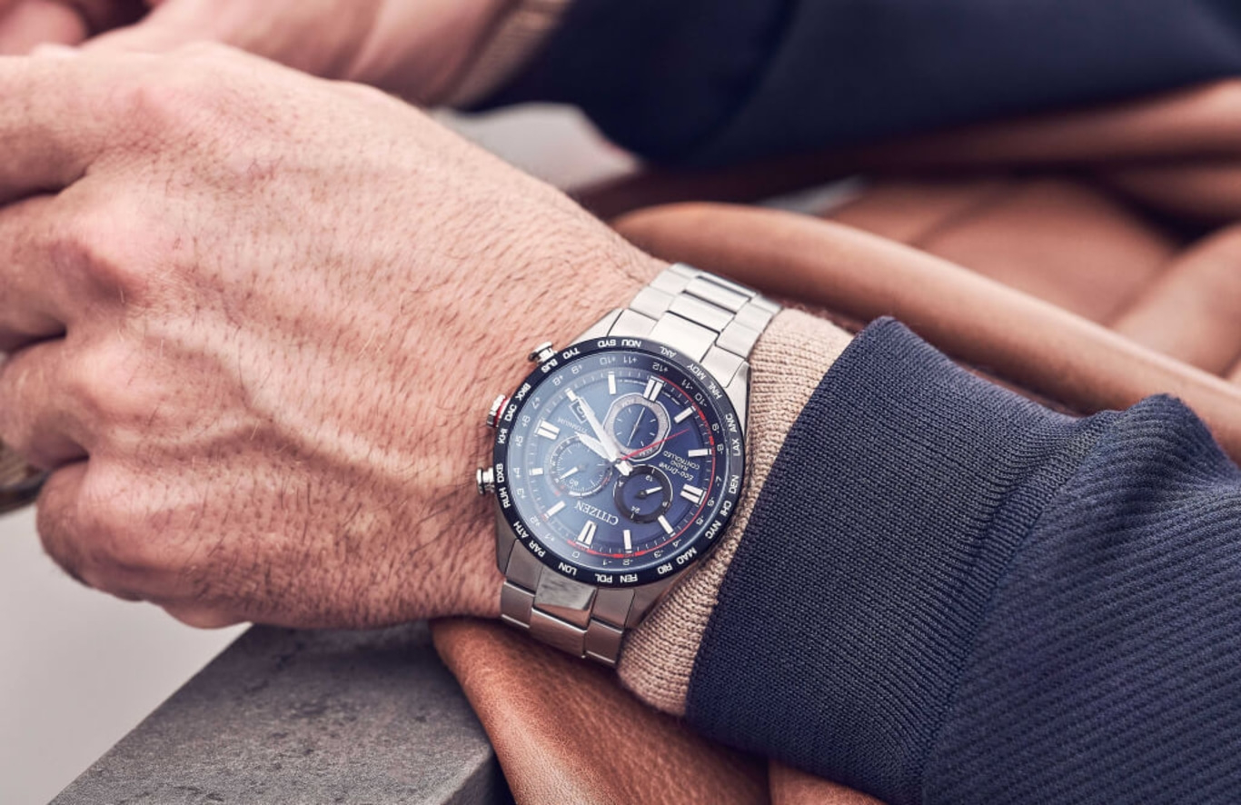 Close-up of a man's wrist with a Citizen watch, showcasing the watch's details.