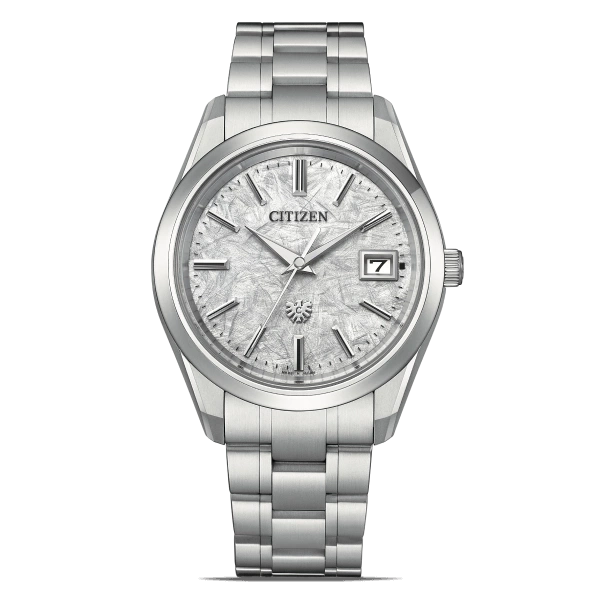 Citizen watch with a silver band and a textured face, date display.