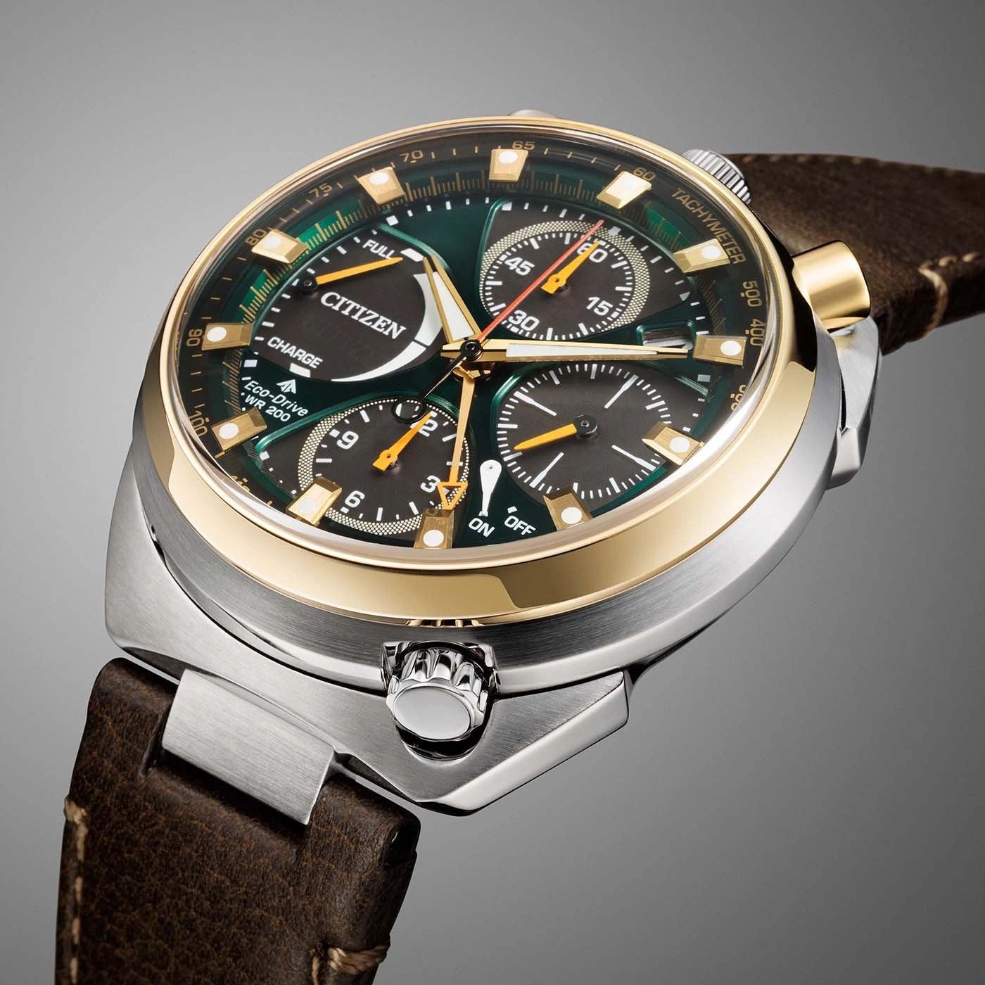 A close-up view of a green Citizen Eco-Drive watch with gold accents and a leather strap.