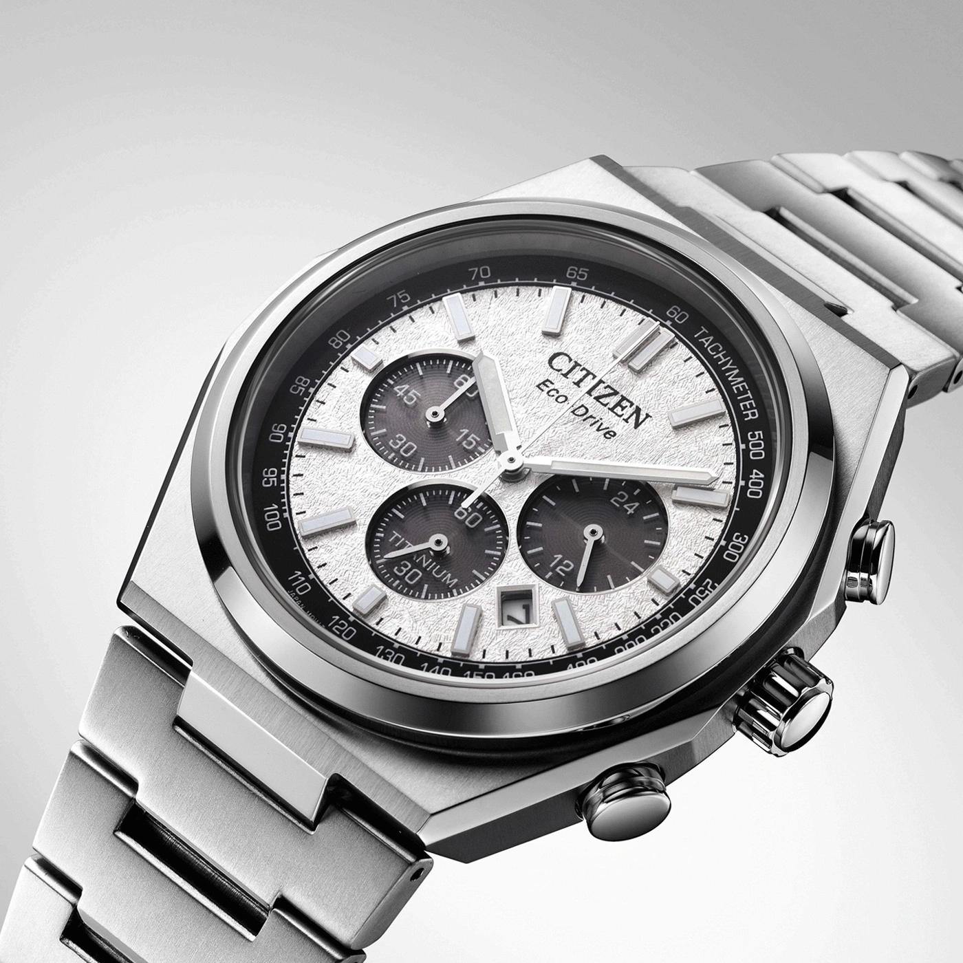 Close-up of a Citizen watch with a silver titanium bracelet and a textured dial.