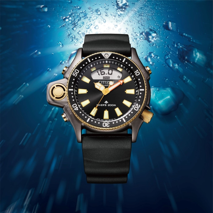 Citizen dive watch with black face and gold accents underwater