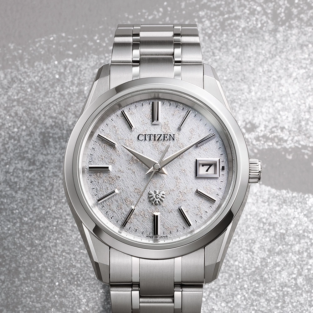 Citizen watch with a silver band and a textured white face, date display.