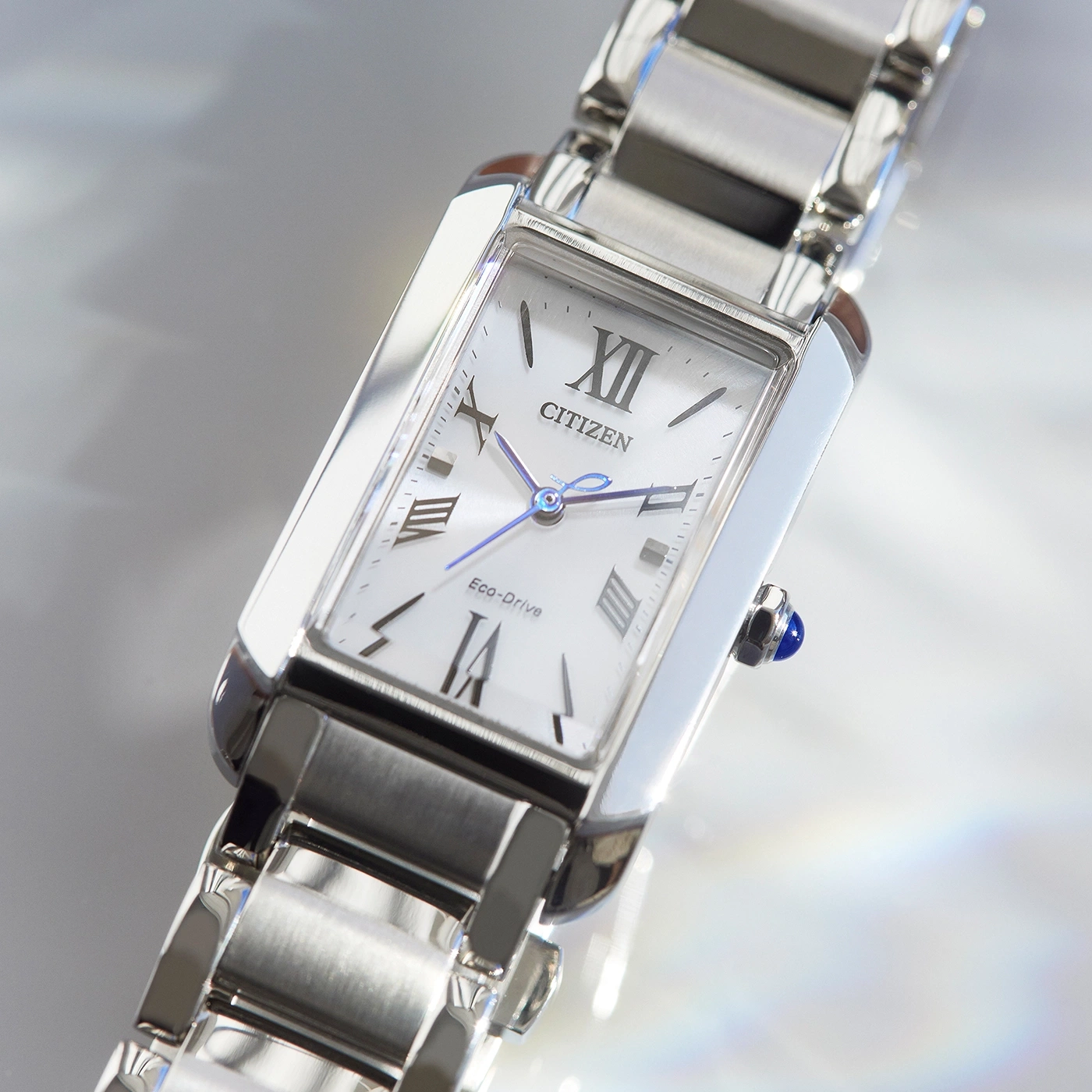 Citizen watch with a white face and silver band, Eco-Drive technology.
