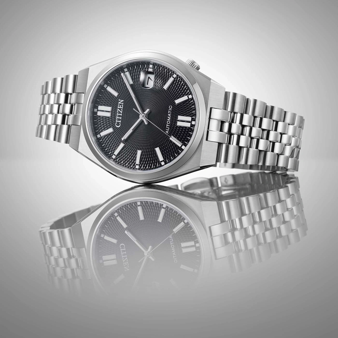 Citizen automatic watch with black dial and stainless steel band.