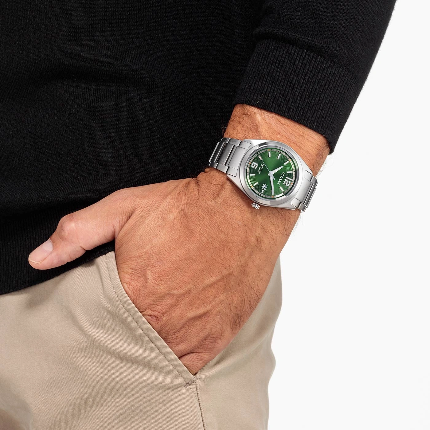 Man wearing a Citizen watch with a green dial and silver bracelet.
