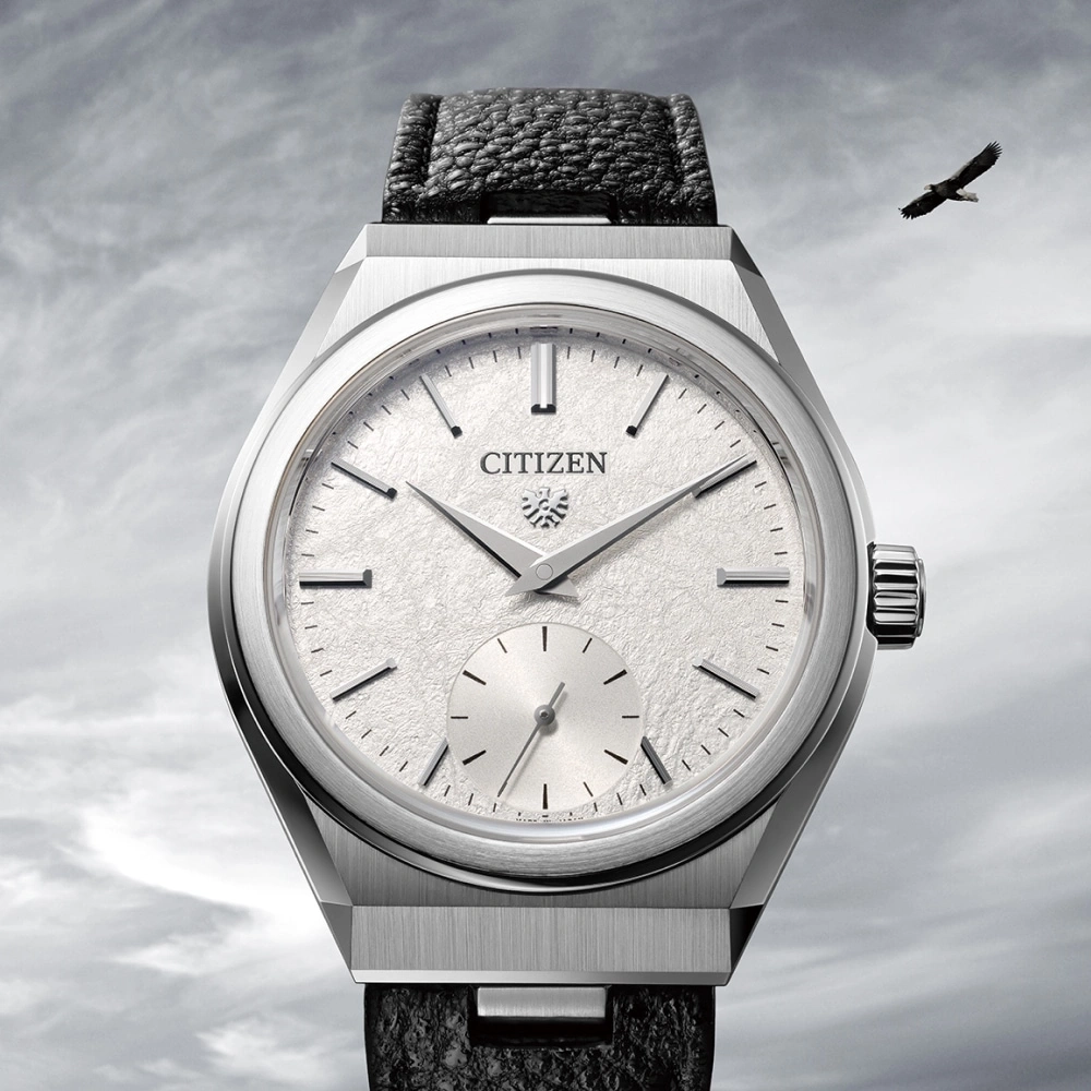 Citizen watch with a textured face and a black leather strap, eagle flying.