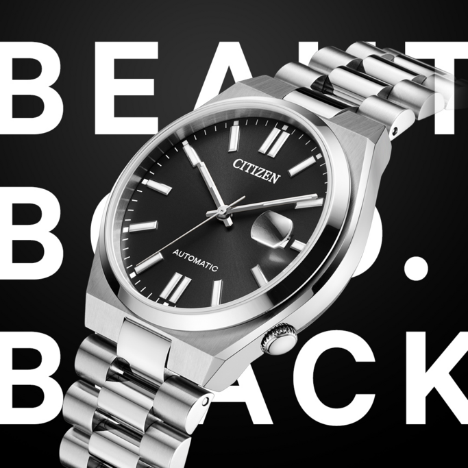A close-up of a Citizen automatic watch with a silver band and black dial, set against a black background with white text "BEAUT BACK".
