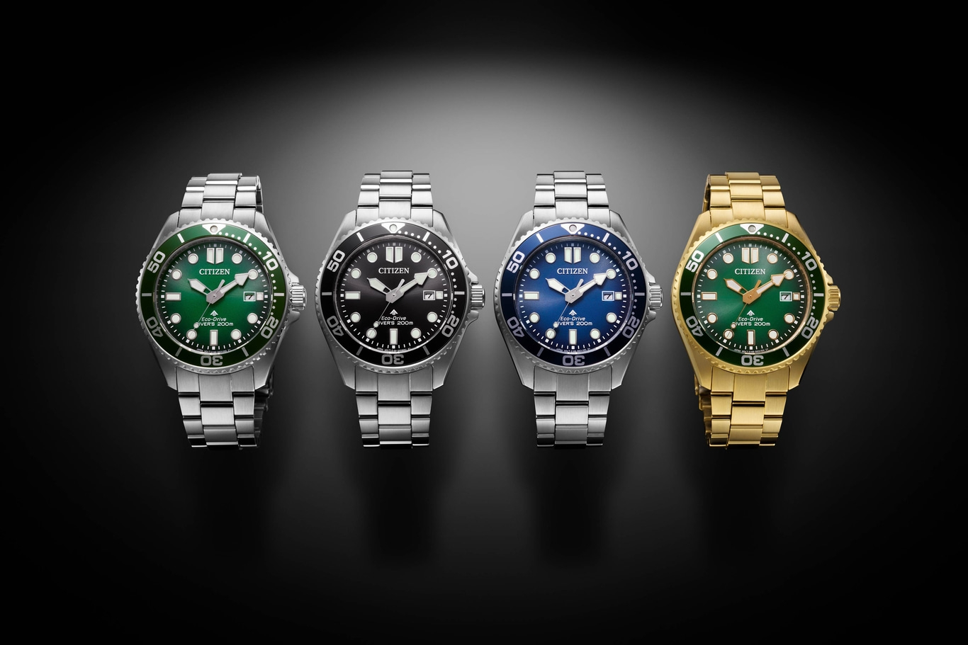 Four Citizen watches with different colored faces and bands, on a black background.