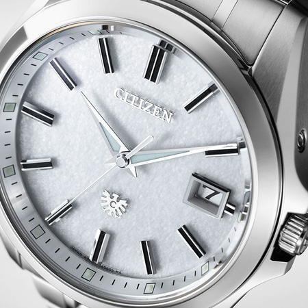 Close-up of a Citizen watch with a silver face and hands.