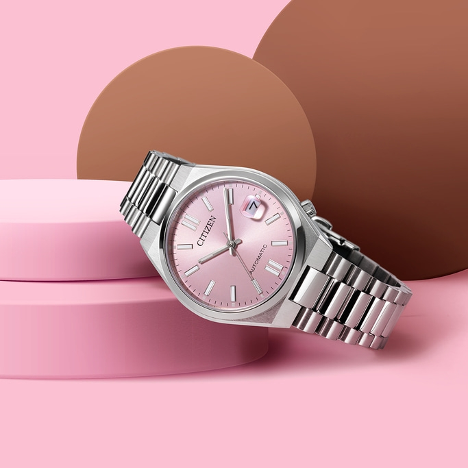 Citizen watch with pink face and silver band on pink background