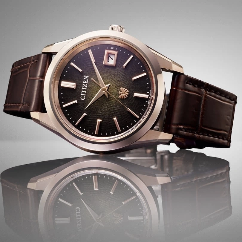 Citizen watch with a brown leather strap and a black dial, elegant design.