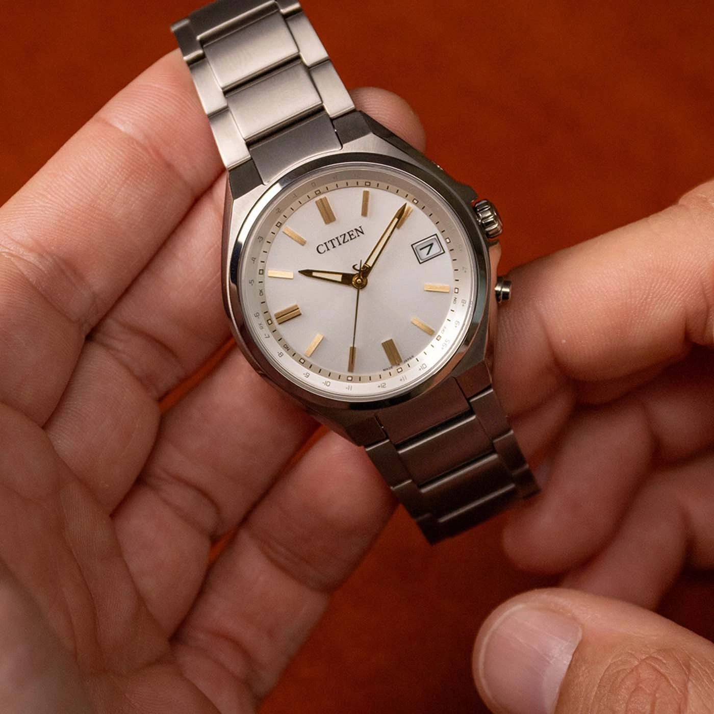 A Citizen watch with a silver dial and metal band.