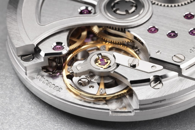 Close-up of a watch mechanism with gears and intricate details.