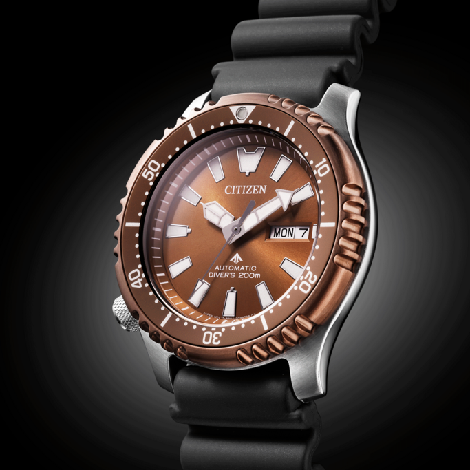 Citizen watch with brown face, black strap, and day display. Automatic diver's watch.