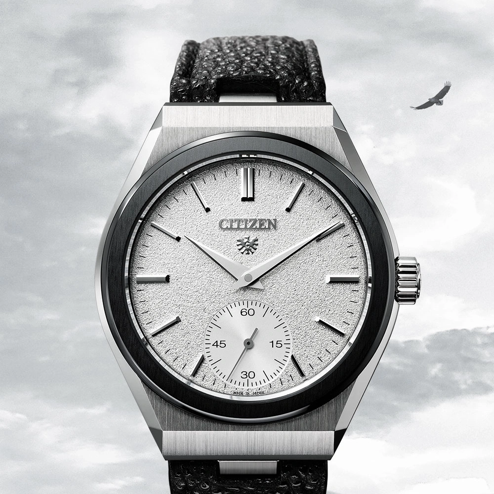 Citizen watch with a textured face and a black leather strap, eagle in the sky.