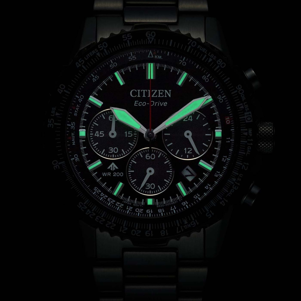 A black Citizen Eco-Drive watch with glowing green hands and markers.
