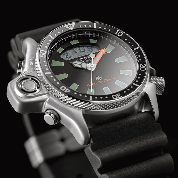 Close-up of a Citizen watch with a black dial and orange hand.