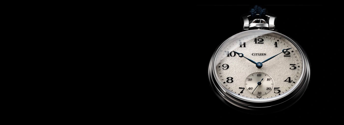 A close-up of a vintage Citizen pocket watch on a black background.