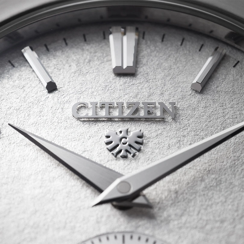 Close-up of a Citizen watch face with silver hands and markers.