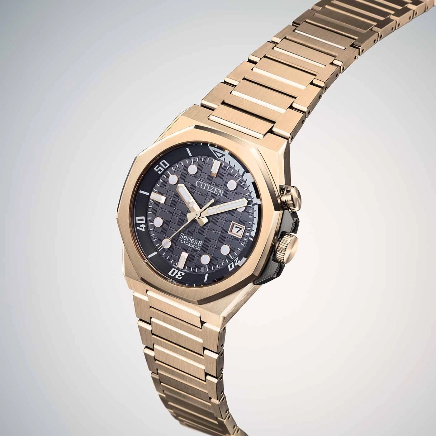 Gold Citizen watch with black face and date display, elegant design.