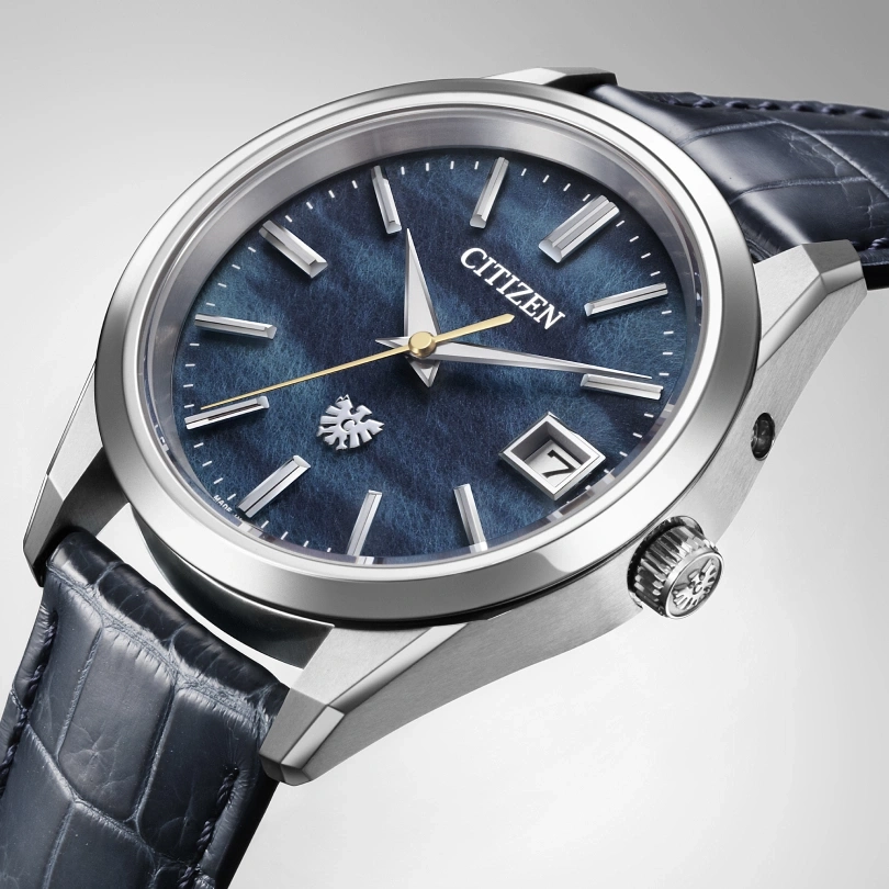 Citizen watch with blue face and leather strap, elegant design, close-up shot.