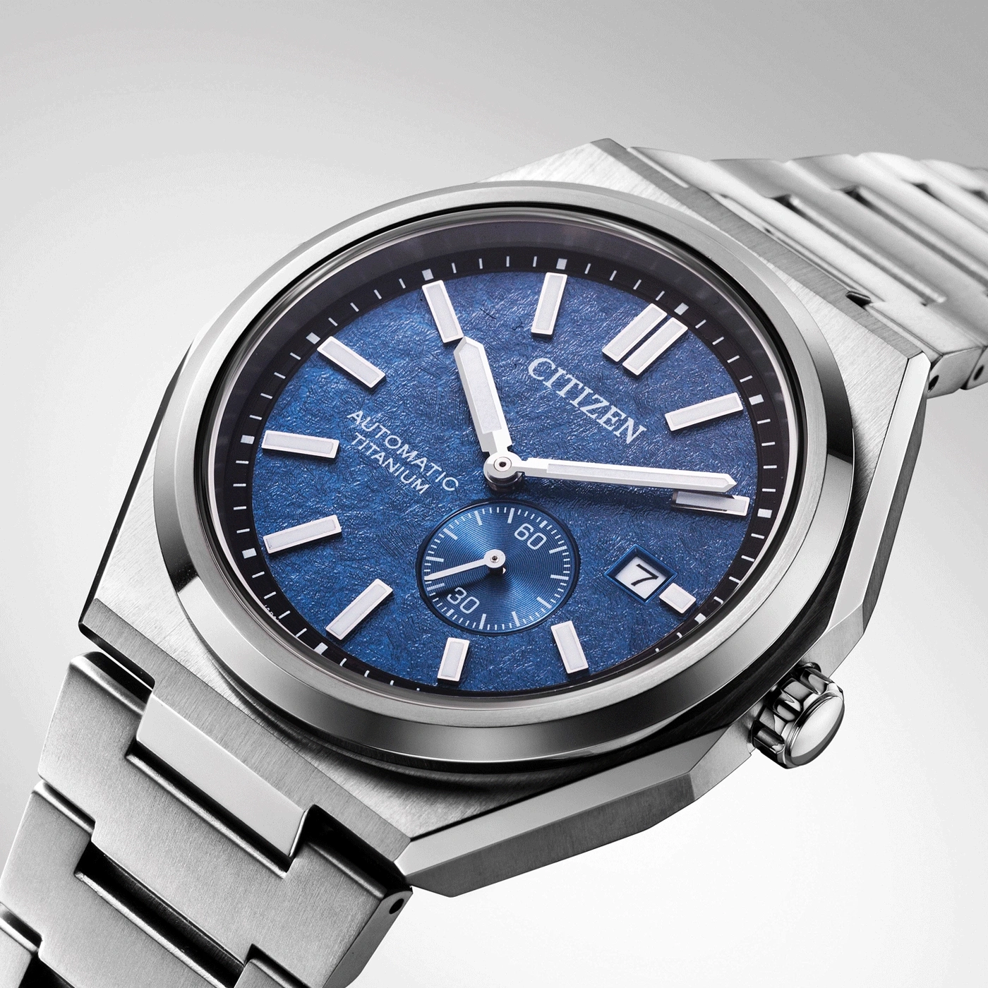 Citizen watch with blue face and titanium band, elegant design, close-up shot