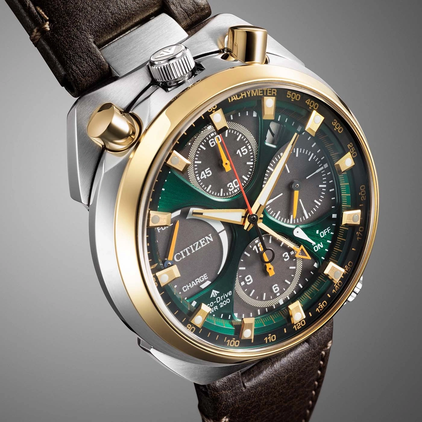 A close-up shot of a green and gold Citizen Eco-Drive chronograph watch with a brown leather strap.