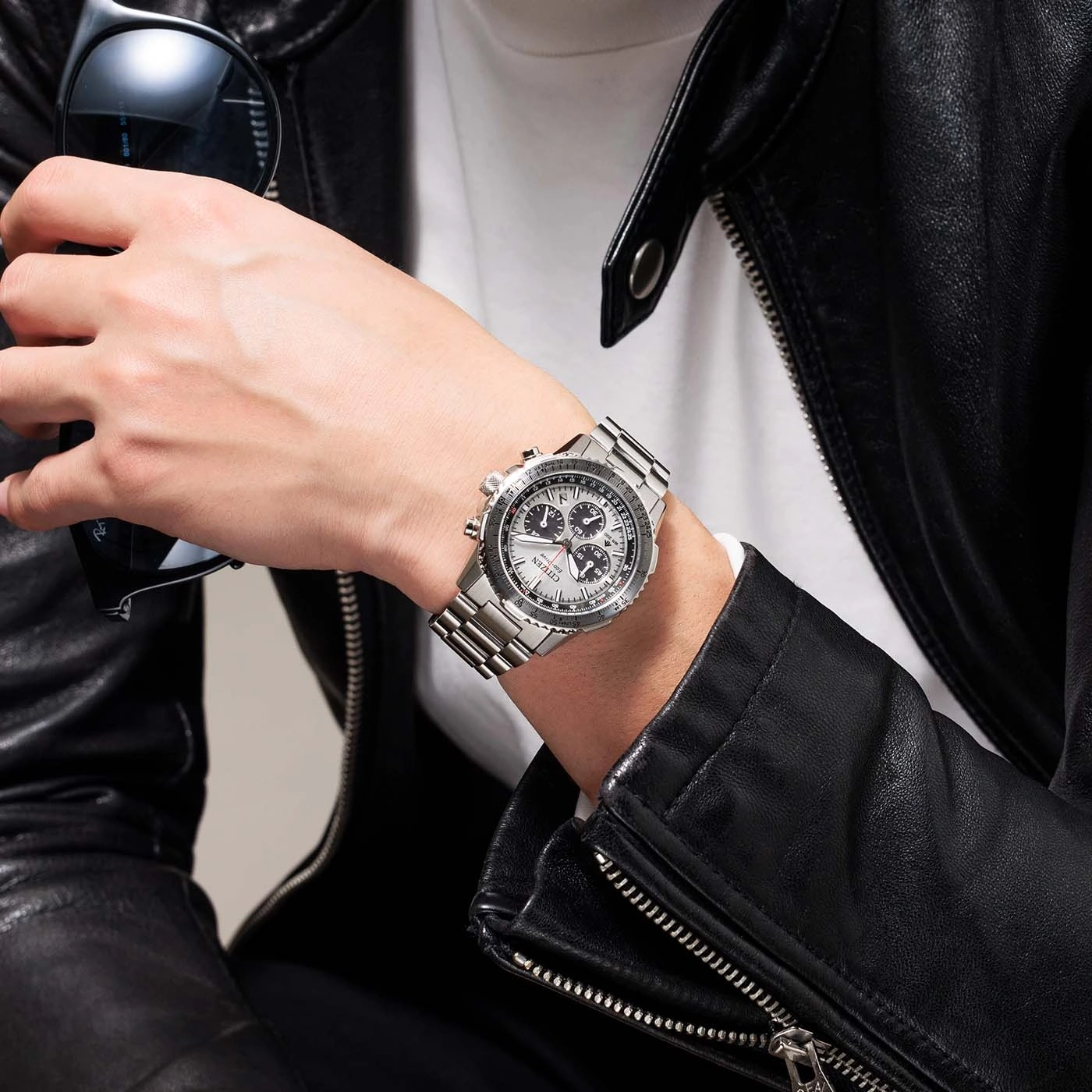 Man wearing a watch and sunglasses, leather jacket, close-up shot