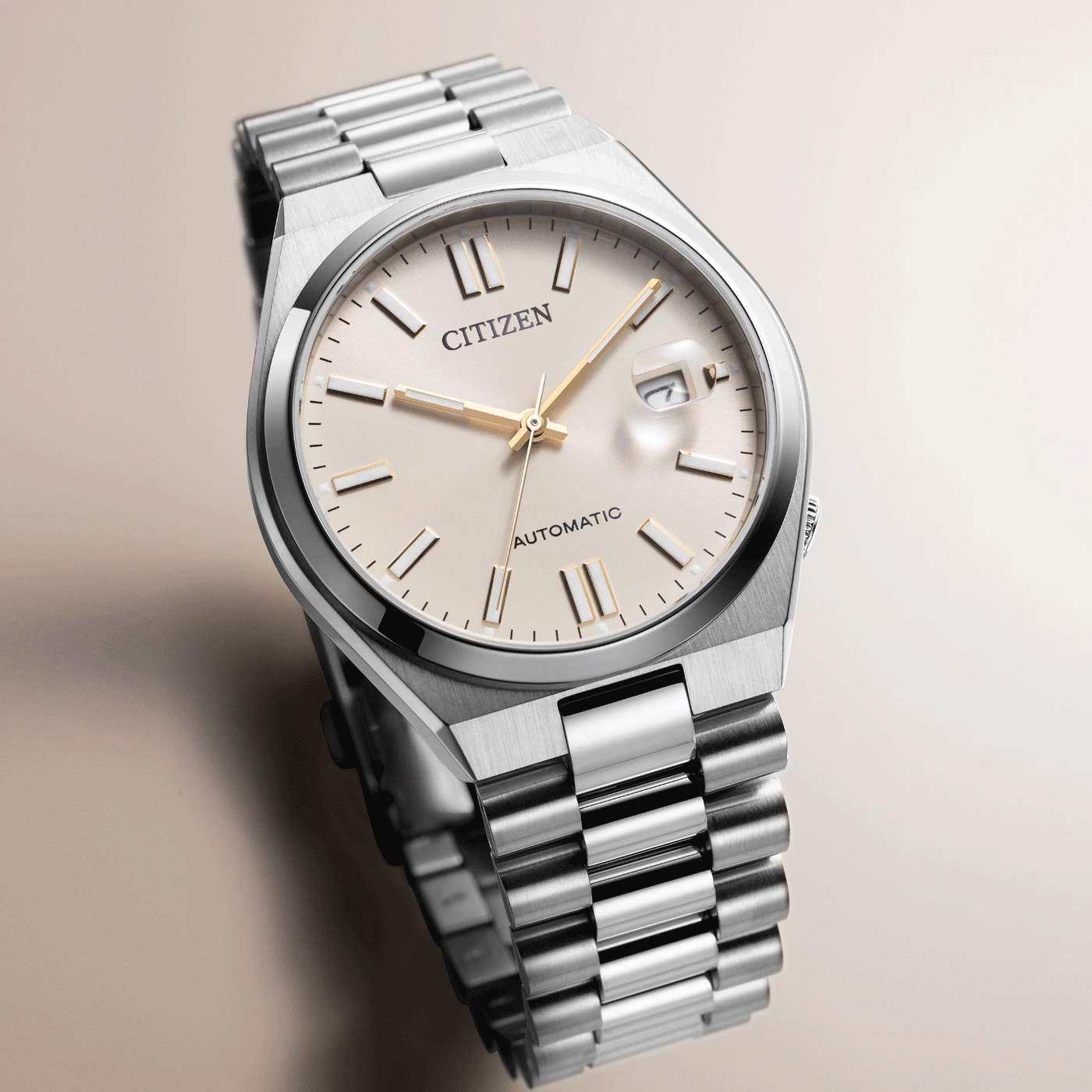 Citizen watch with silver strap and cream face, automatic movement.