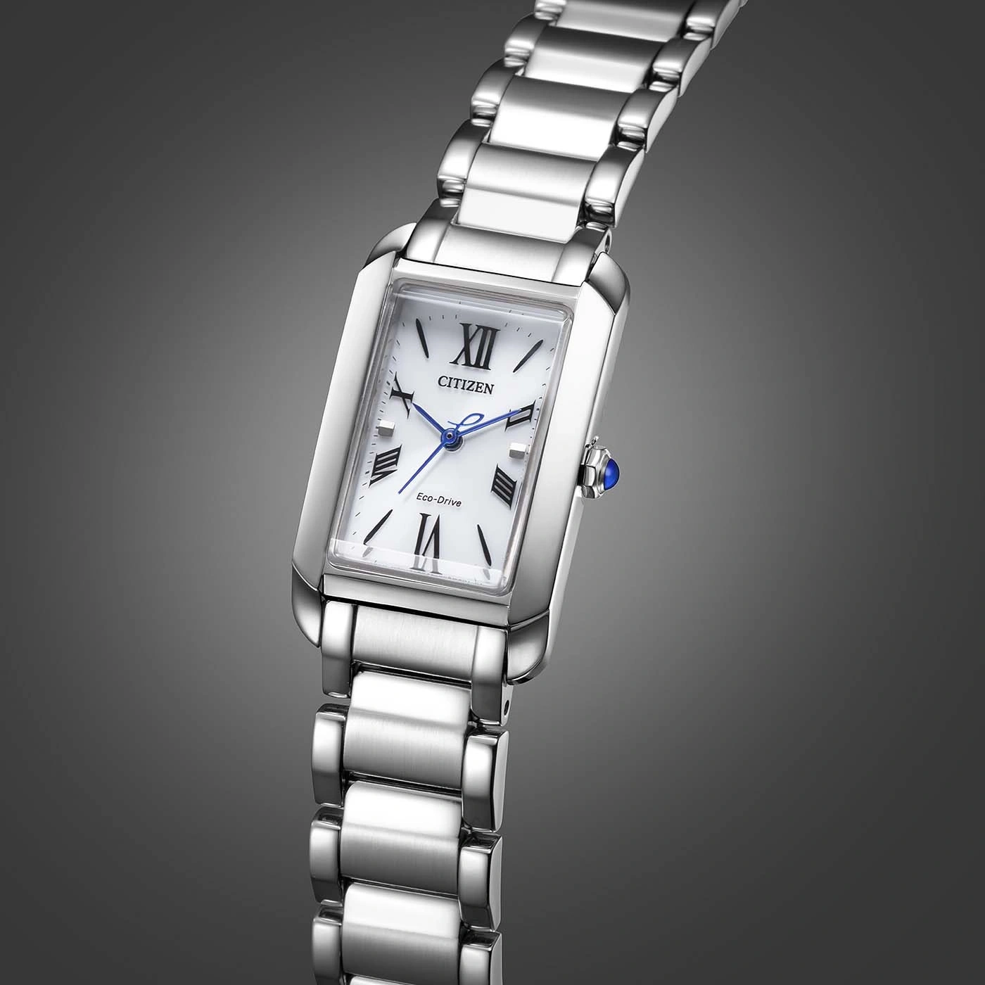 Citizen watch with a white face and silver band on a gray background