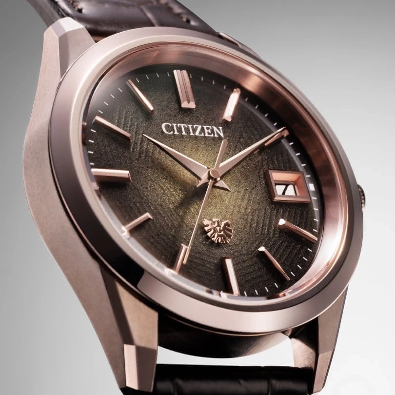 Citizen watch with rose gold accents and a textured dark green face