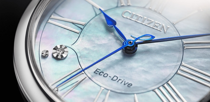 Close-up of a Citizen Eco-Drive watch with blue hands and Roman numerals.