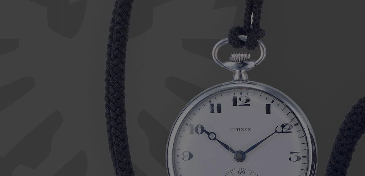 Close-up of a Citizen pocket watch with a black cord, elegant and vintage.